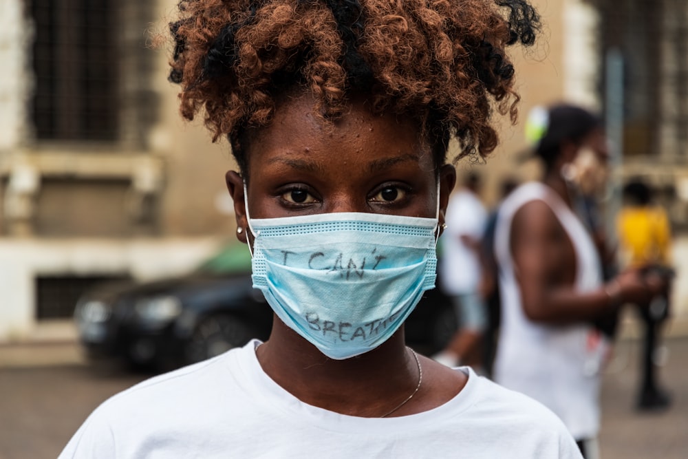 a woman wearing a face mask with the word calm on it