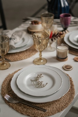 a table set for a formal dinner with place settings