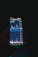 a person holding a cell phone in their hand