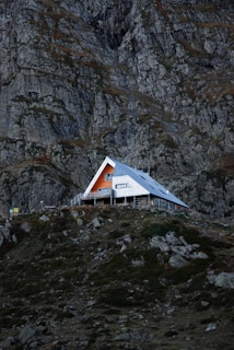 a house on a hill with a mountain in the background