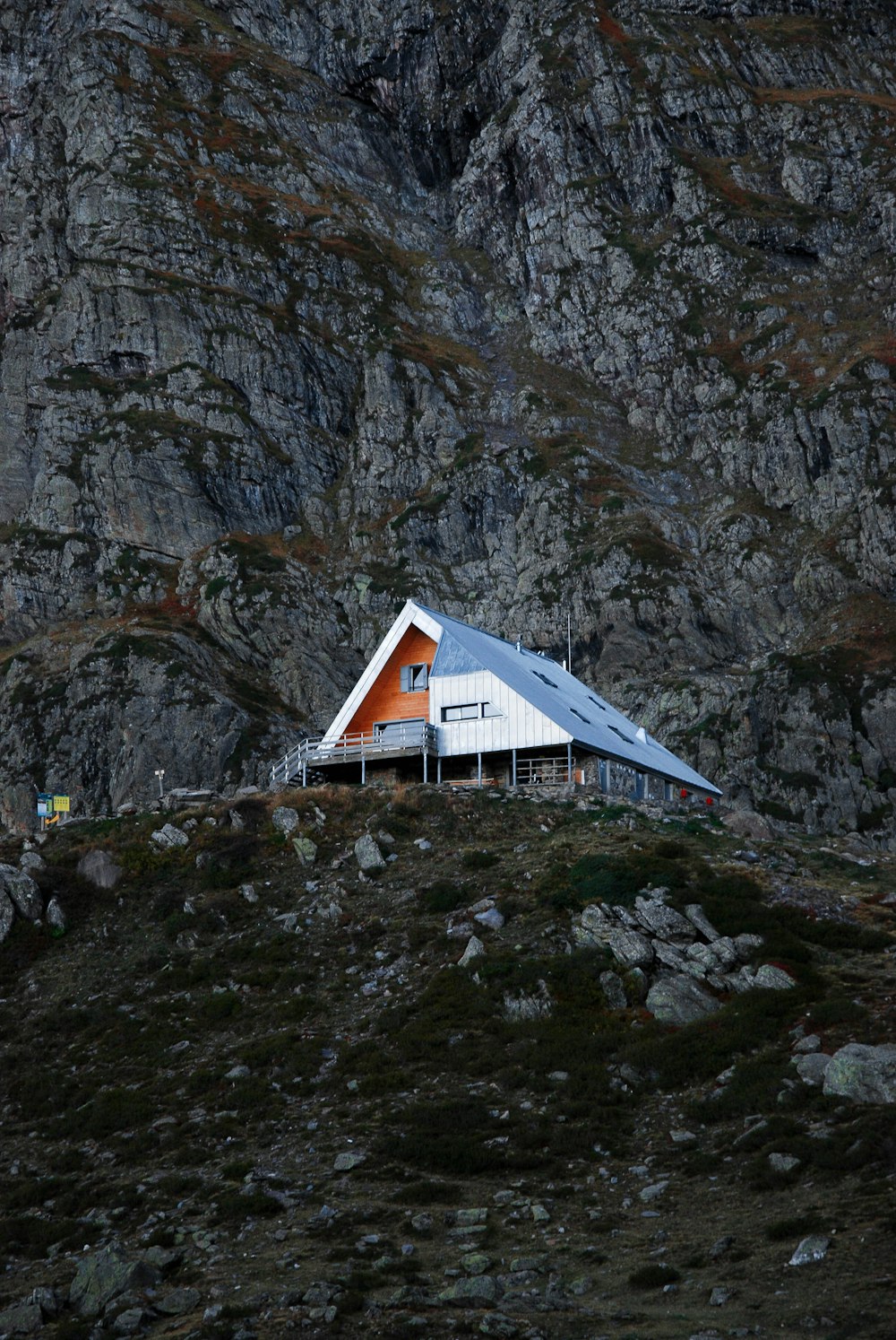 a house on a hill with a mountain in the background