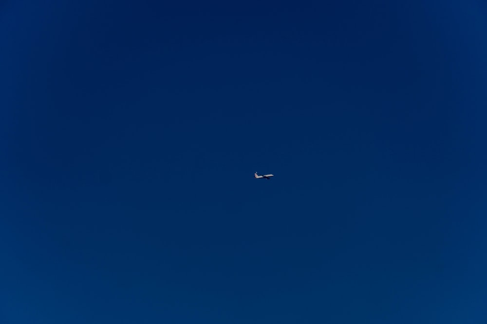 an airplane is flying high in the sky