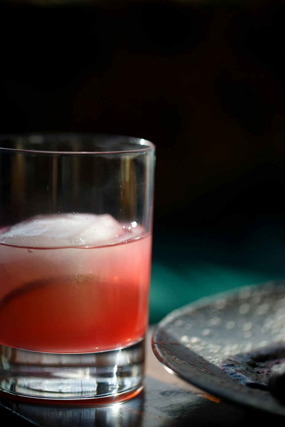 a close up of a drink in a glass on a table