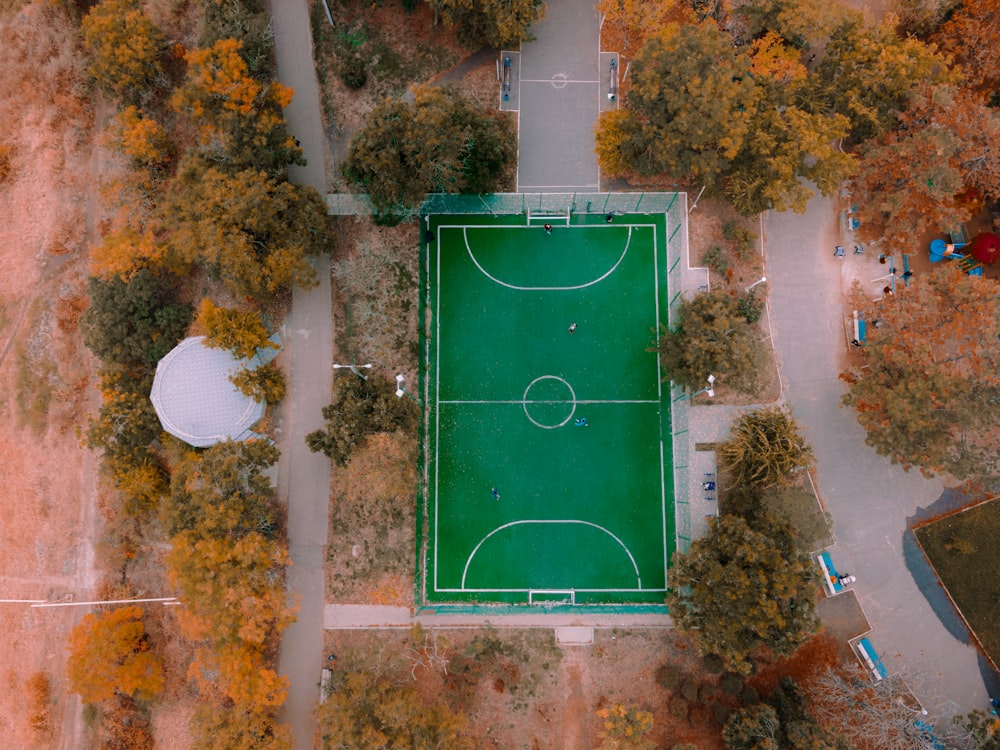 an aerial view of a basketball court surrounded by trees