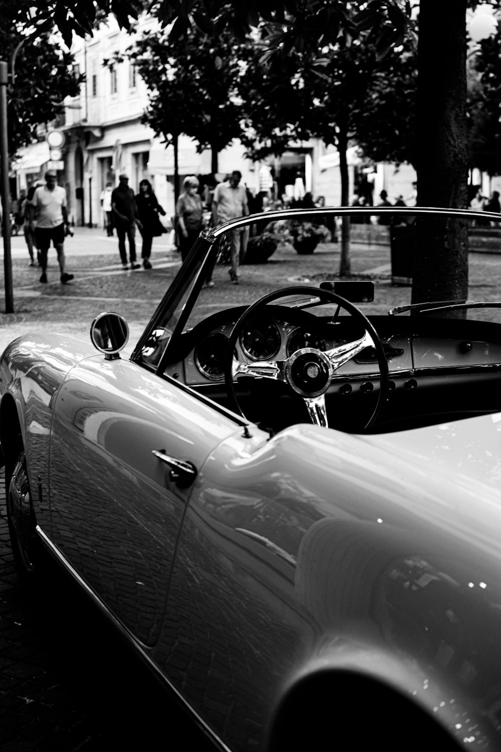 a black and white photo of a convertible car