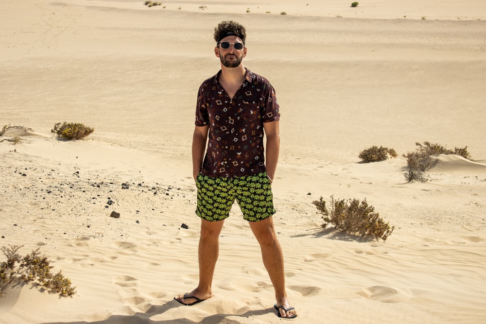 a man standing on top of a sandy beach