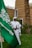 a man standing next to a green flag