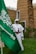 a man standing next to a green flag