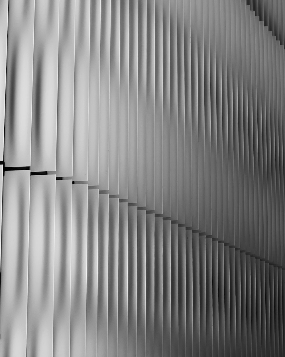 a black and white photo of a metal wall