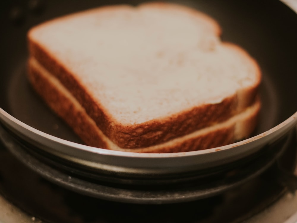 a close up of a sandwich in a pan on a stove