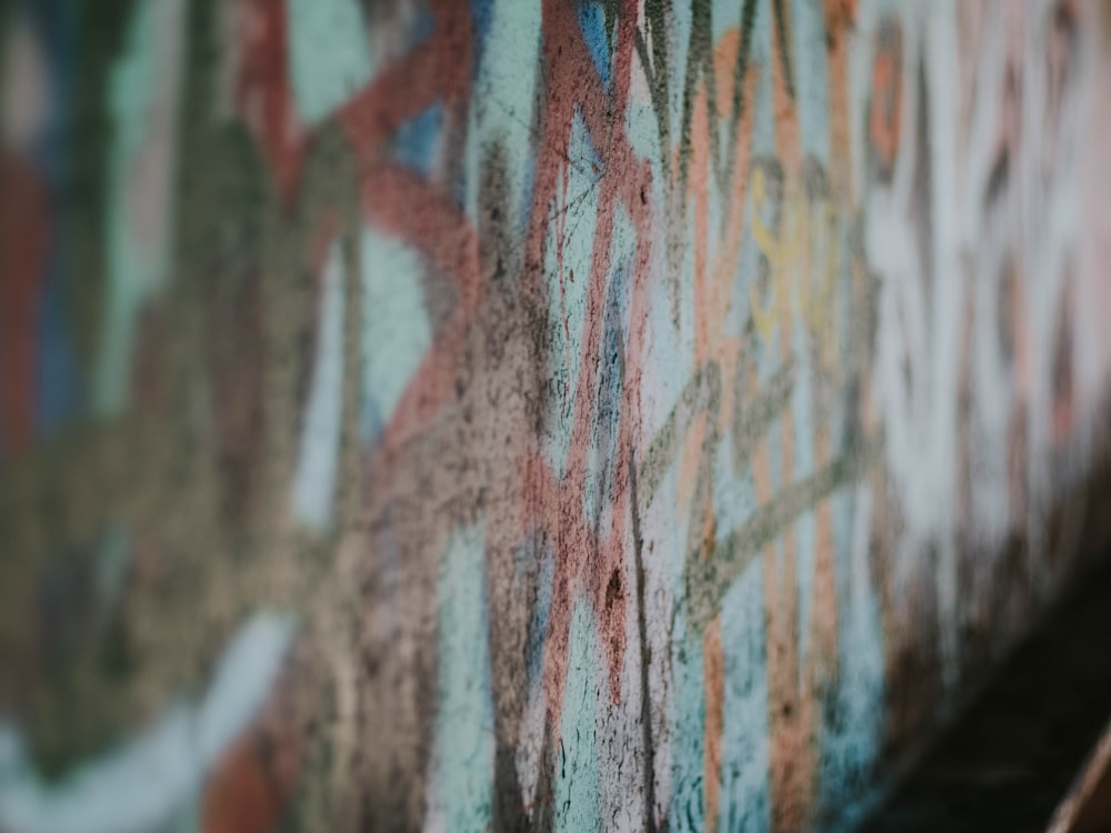 a close up of a wall with graffiti on it