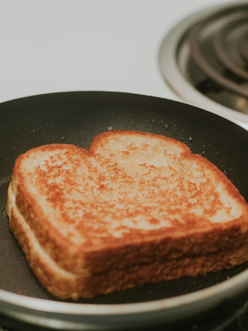 a toasted sandwich sitting on top of a black pan