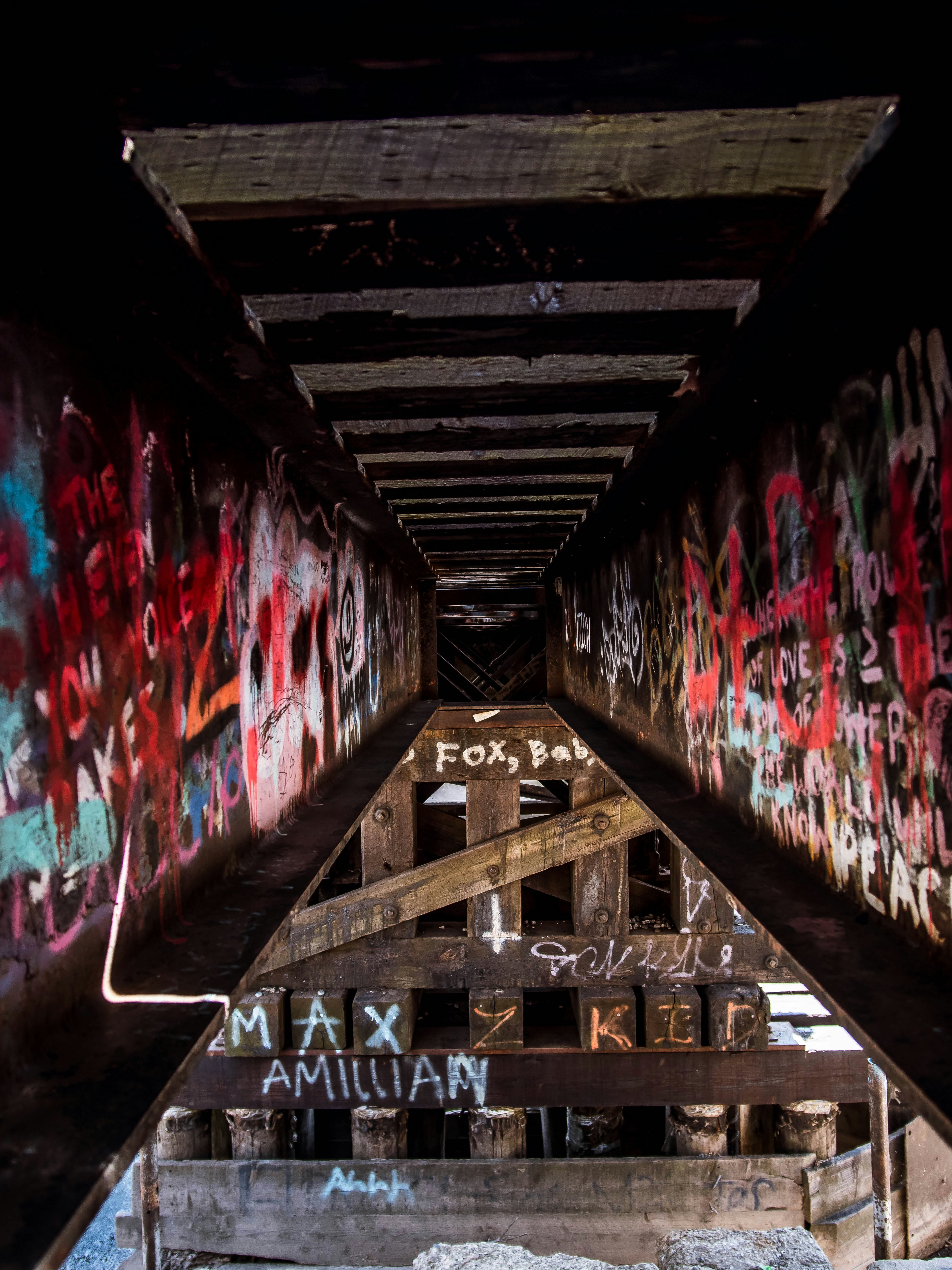 a very long bridge with some graffiti on it