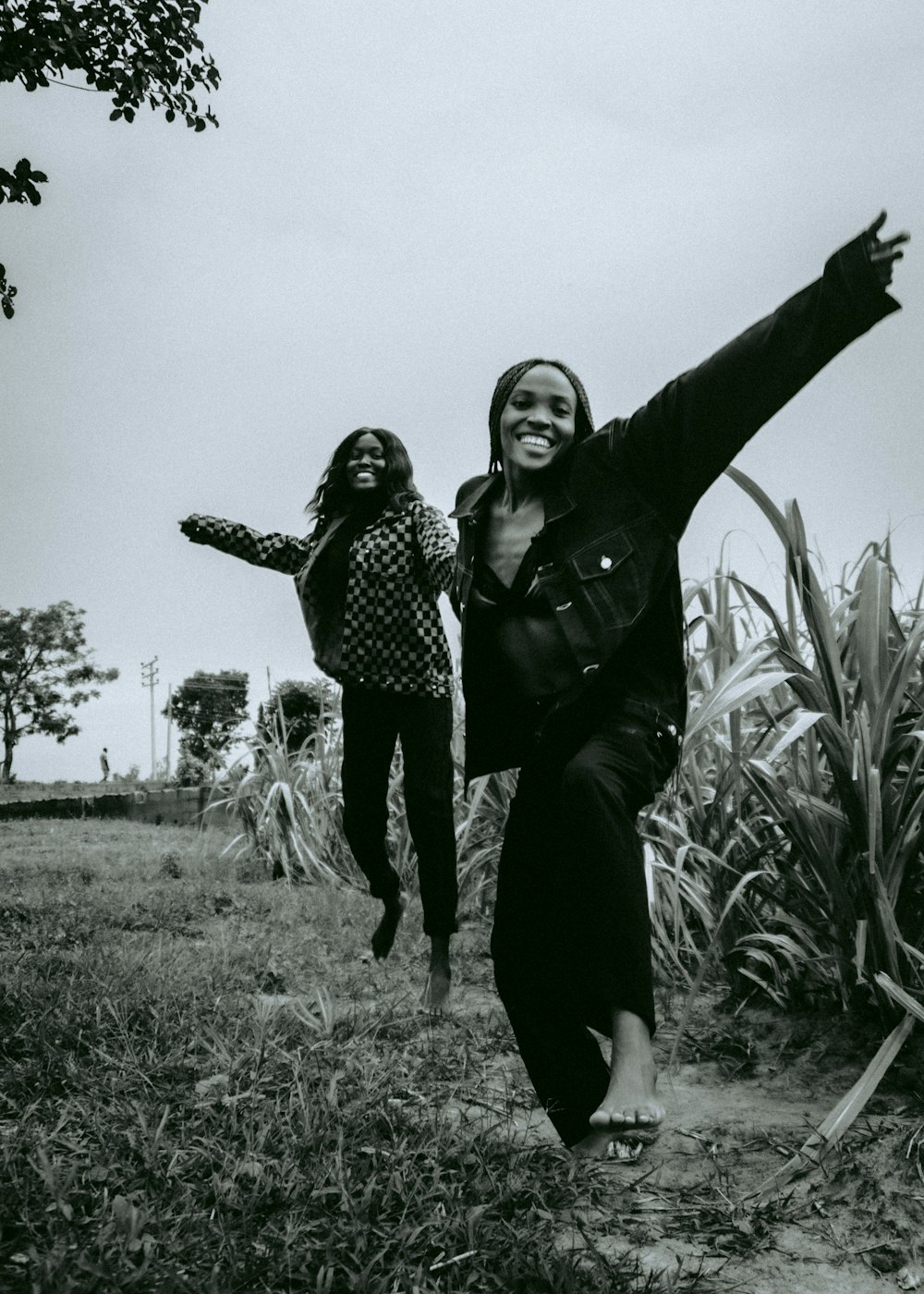 two women are running through a field together