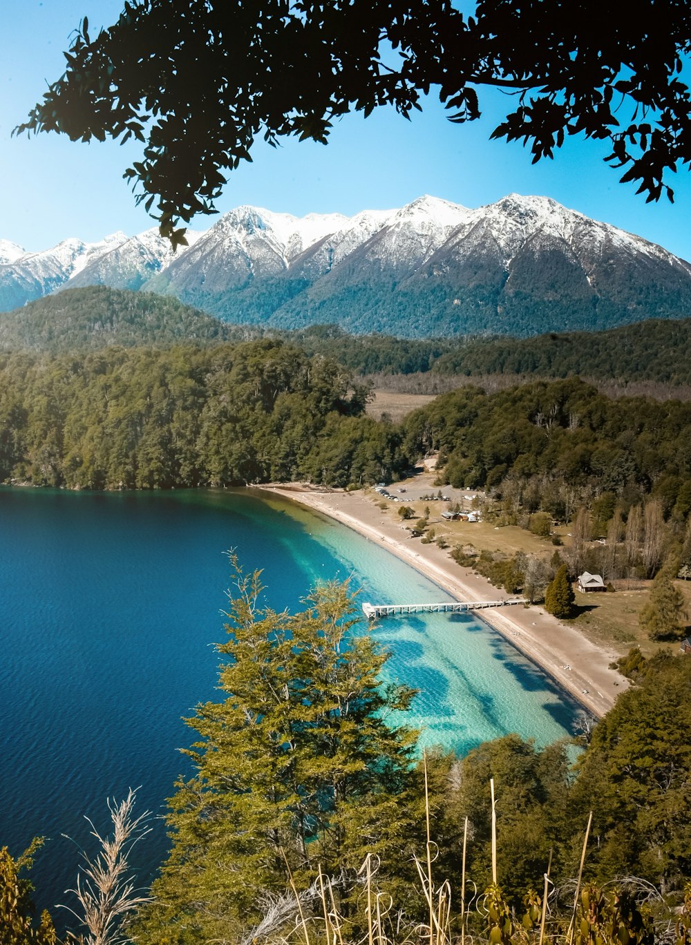 a lake surrounded by trees and mountains