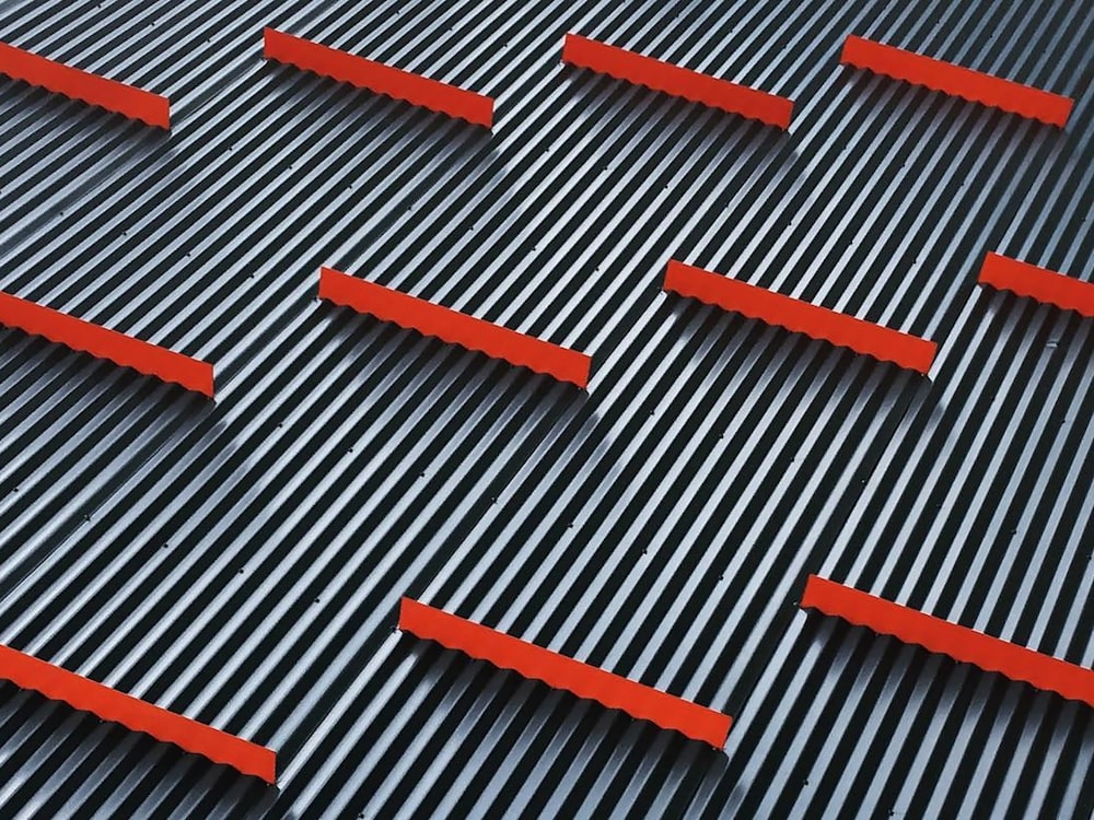 a close up of a metal structure with red bars
