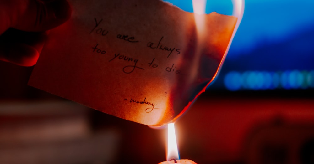 a person holding a piece of paper with writing on it