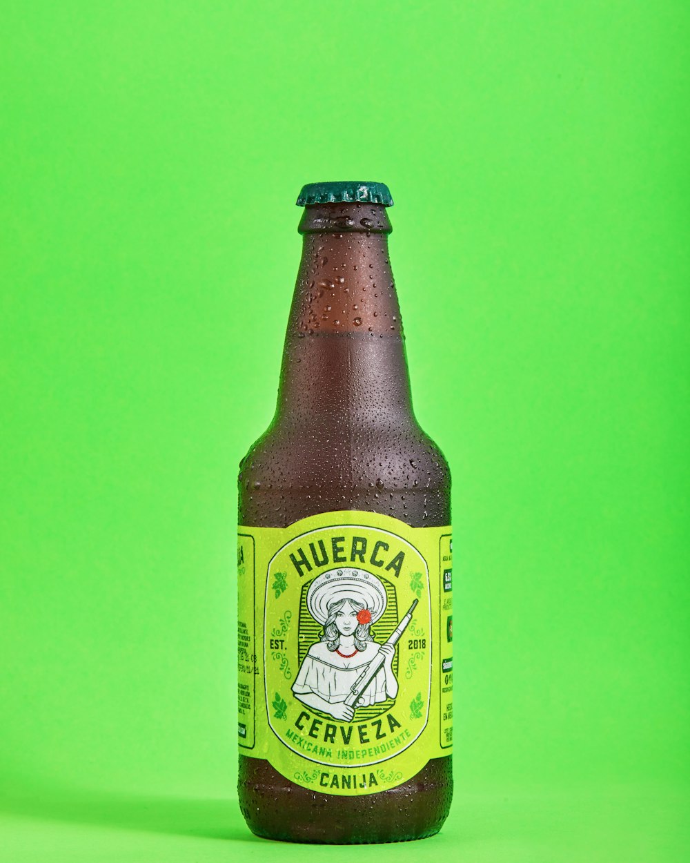 a bottle of beer on a green background