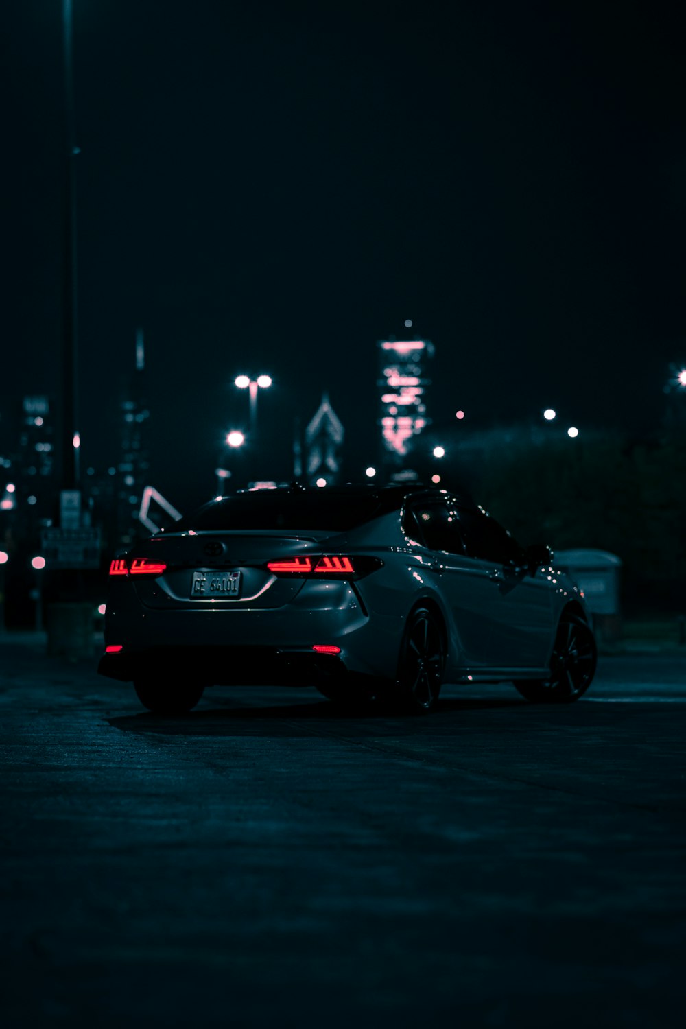 a car parked in a parking lot at night