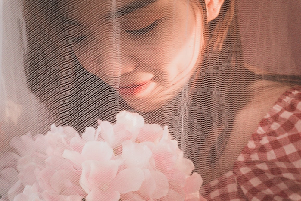 a young woman holding a bouquet of flowers