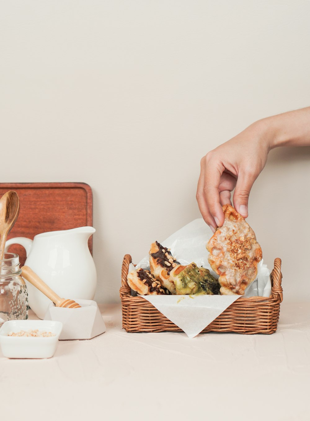 a person putting food in a basket on a table