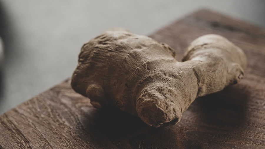 Fresh ginger root on a wooden board
