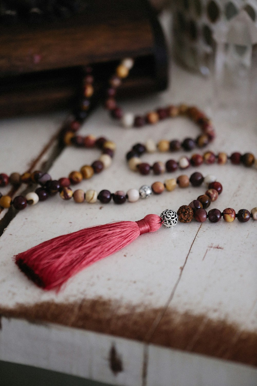 a rosary with a tassel and a red tassel