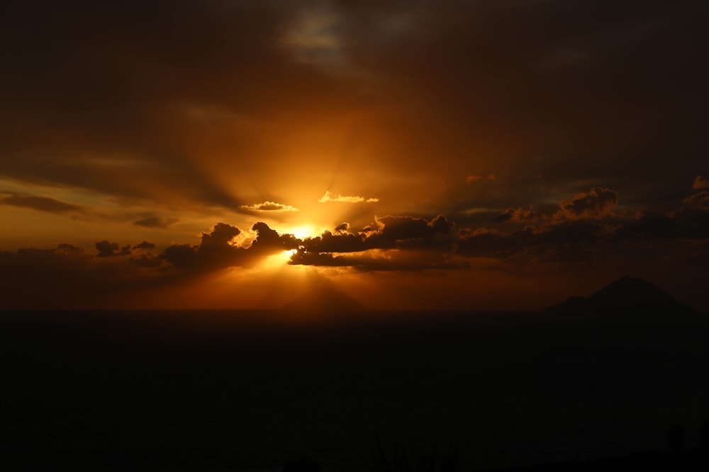 the sun is shining through the clouds in the sky