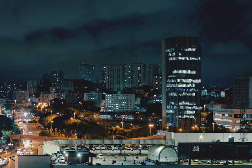 a night view of a city with tall buildings