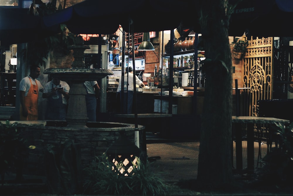 a group of people standing in front of a store