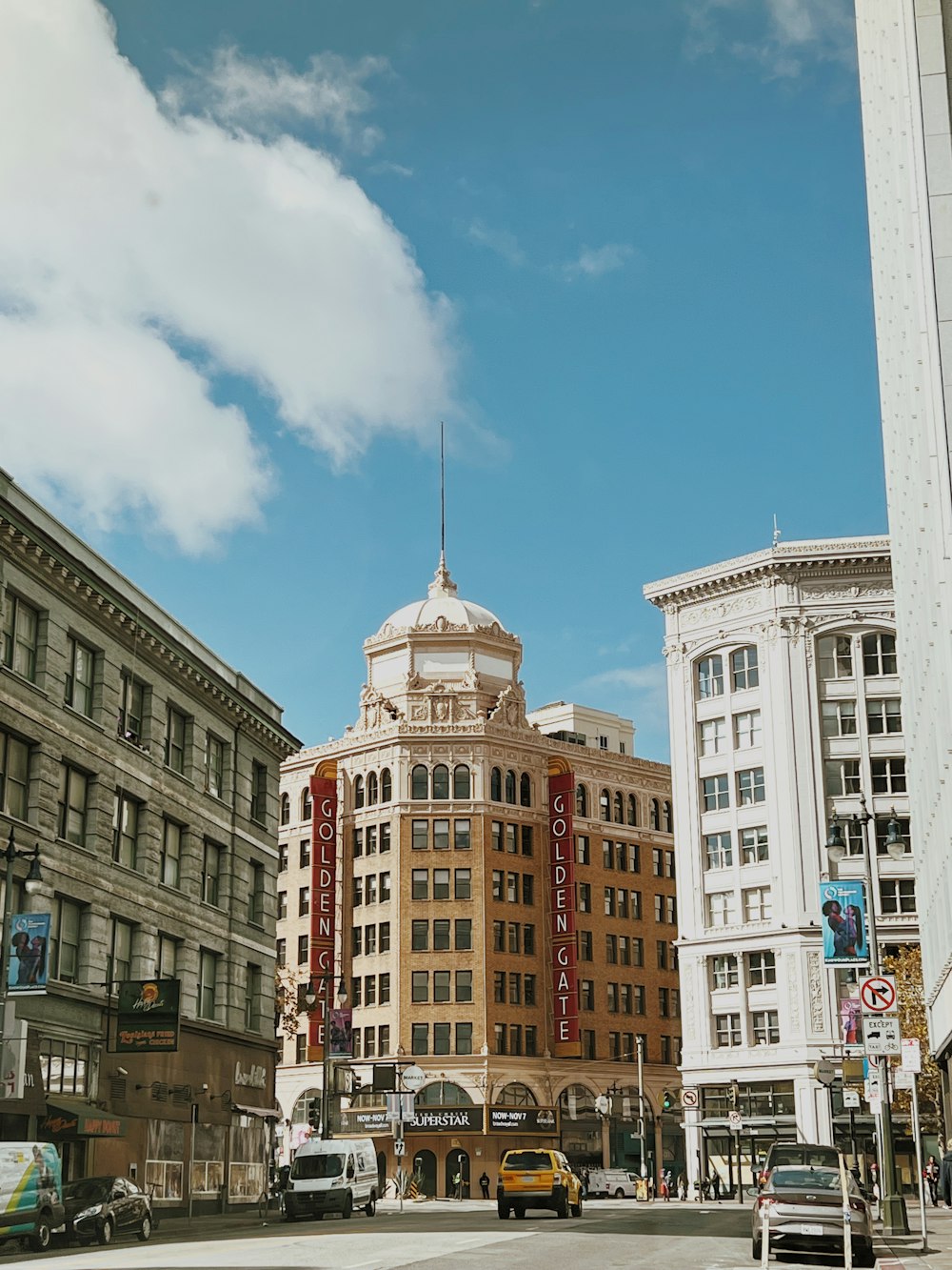 a city street filled with traffic and tall buildings