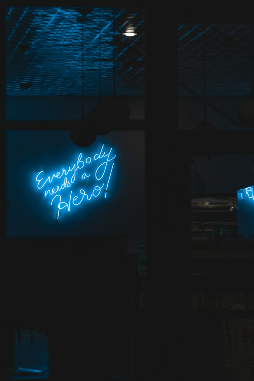 a couple of neon signs hanging from the side of a building