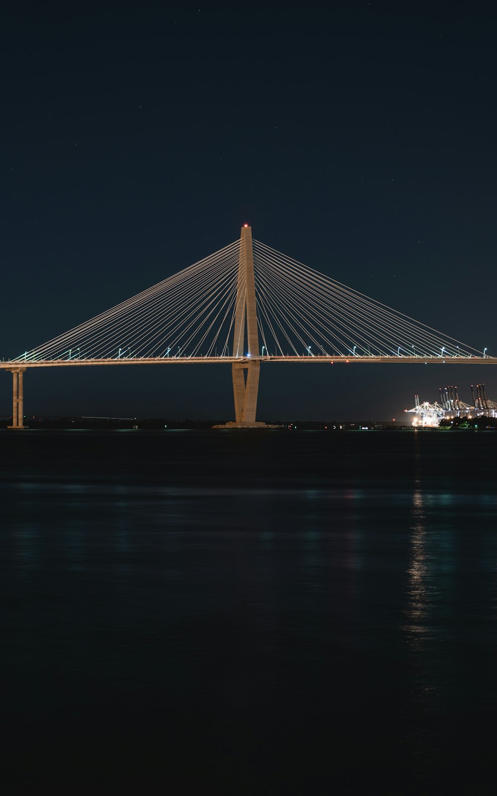 a large bridge over a body of water at night