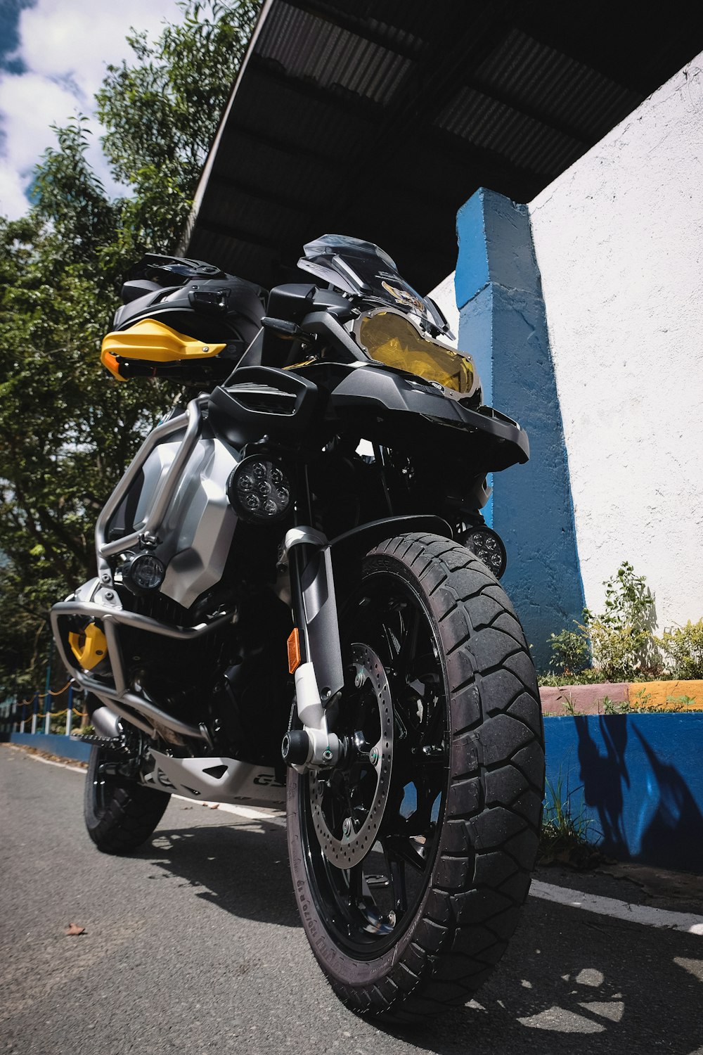 a black and yellow motorcycle parked in front of a building