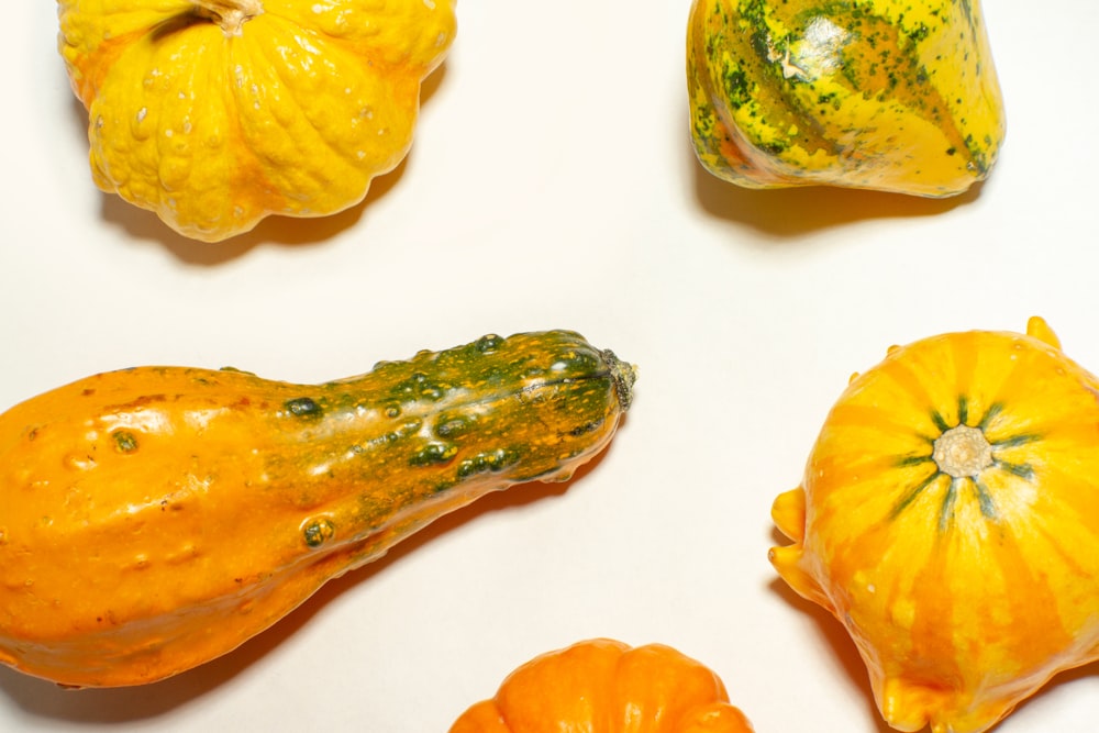 a group of pumpkins sitting on top of a white table