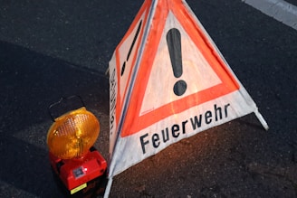 a warning sign sitting on the side of a road