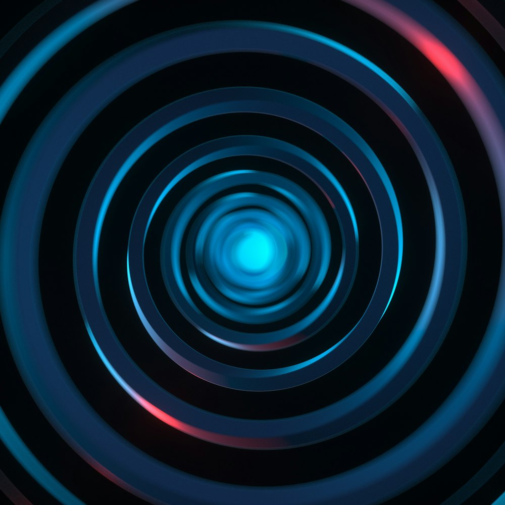 un patrón circular azul y rojo con un fondo negro