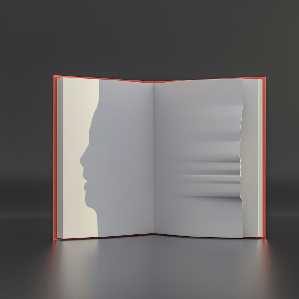 an open book with a shadow of a person