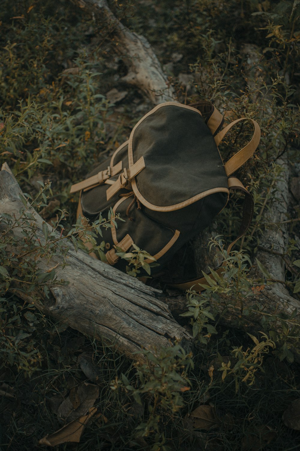 a backpack sitting on top of a pile of wood