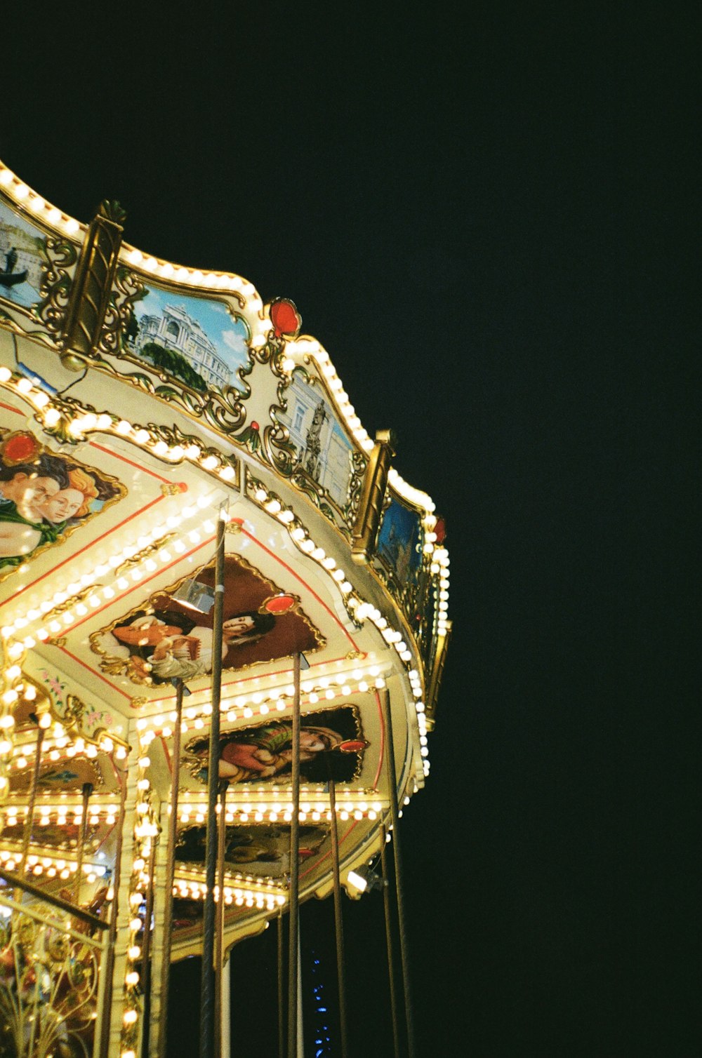 a close up of a merry go round at night