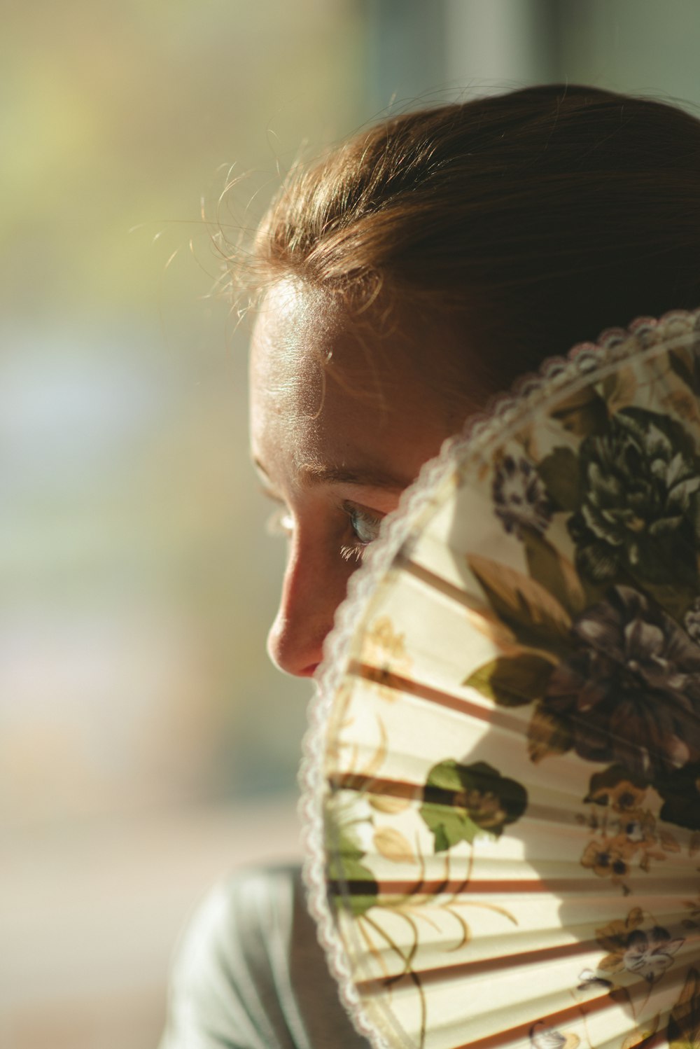 a woman with a floral fan in her hand