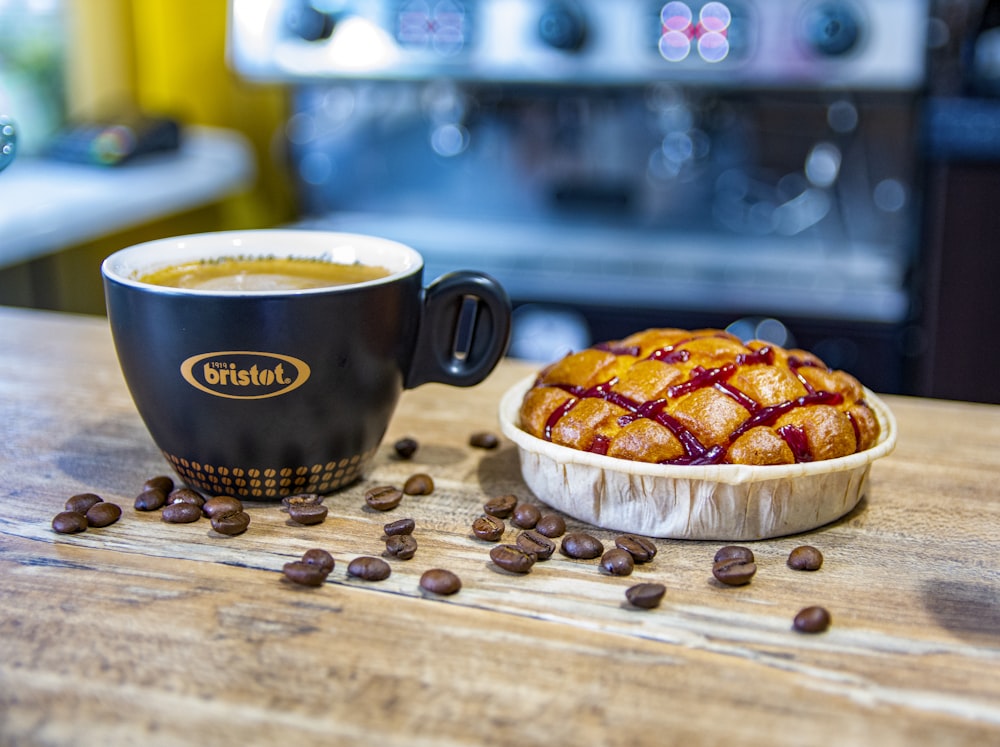 a cup of coffee and a pastry on a table