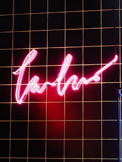 A stylish pink neon sign illuminating a modern space.
