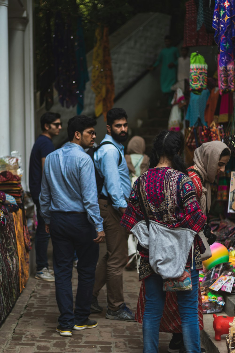 a group of people standing outside of a store