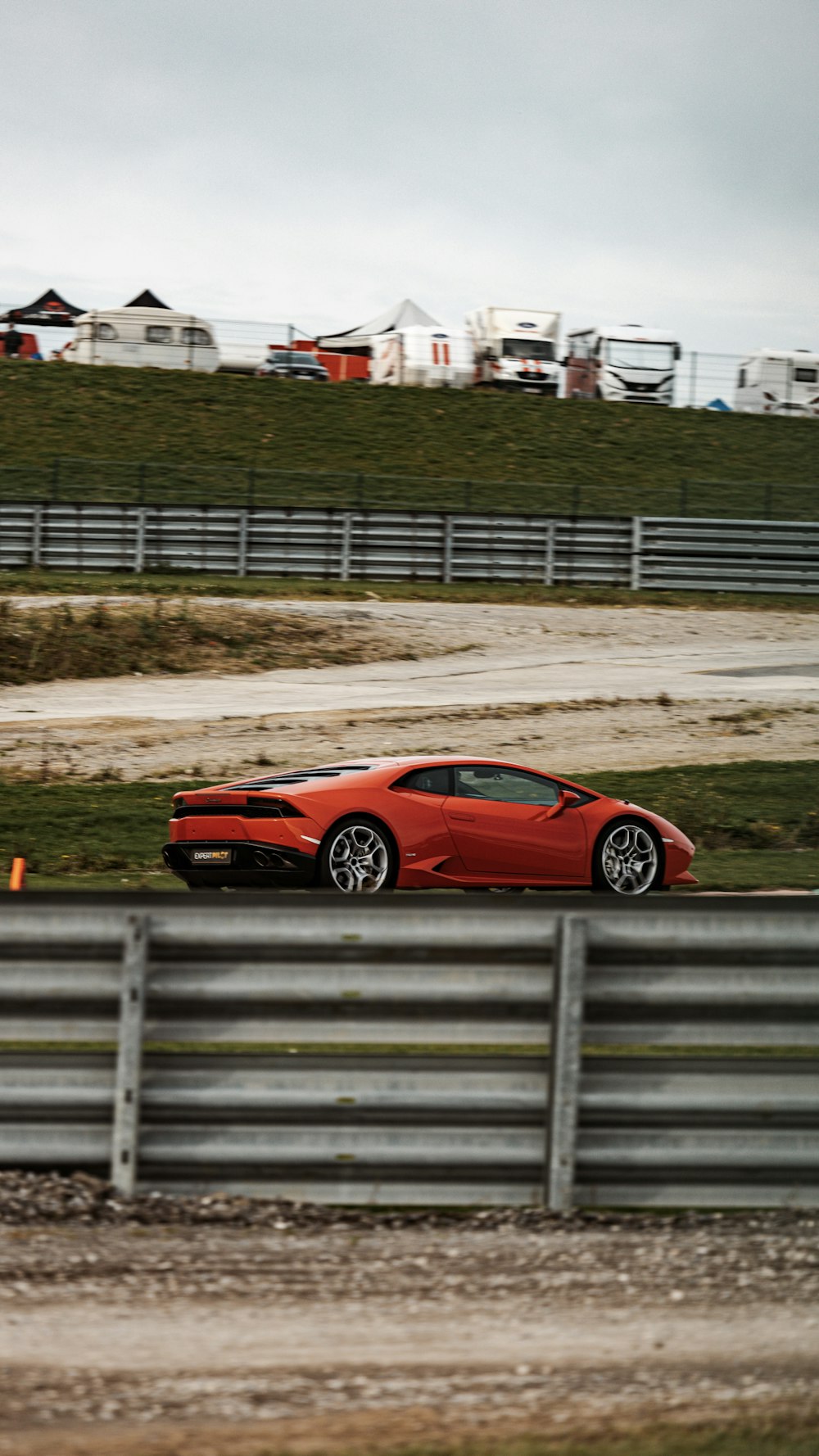 a red sports car driving on a track