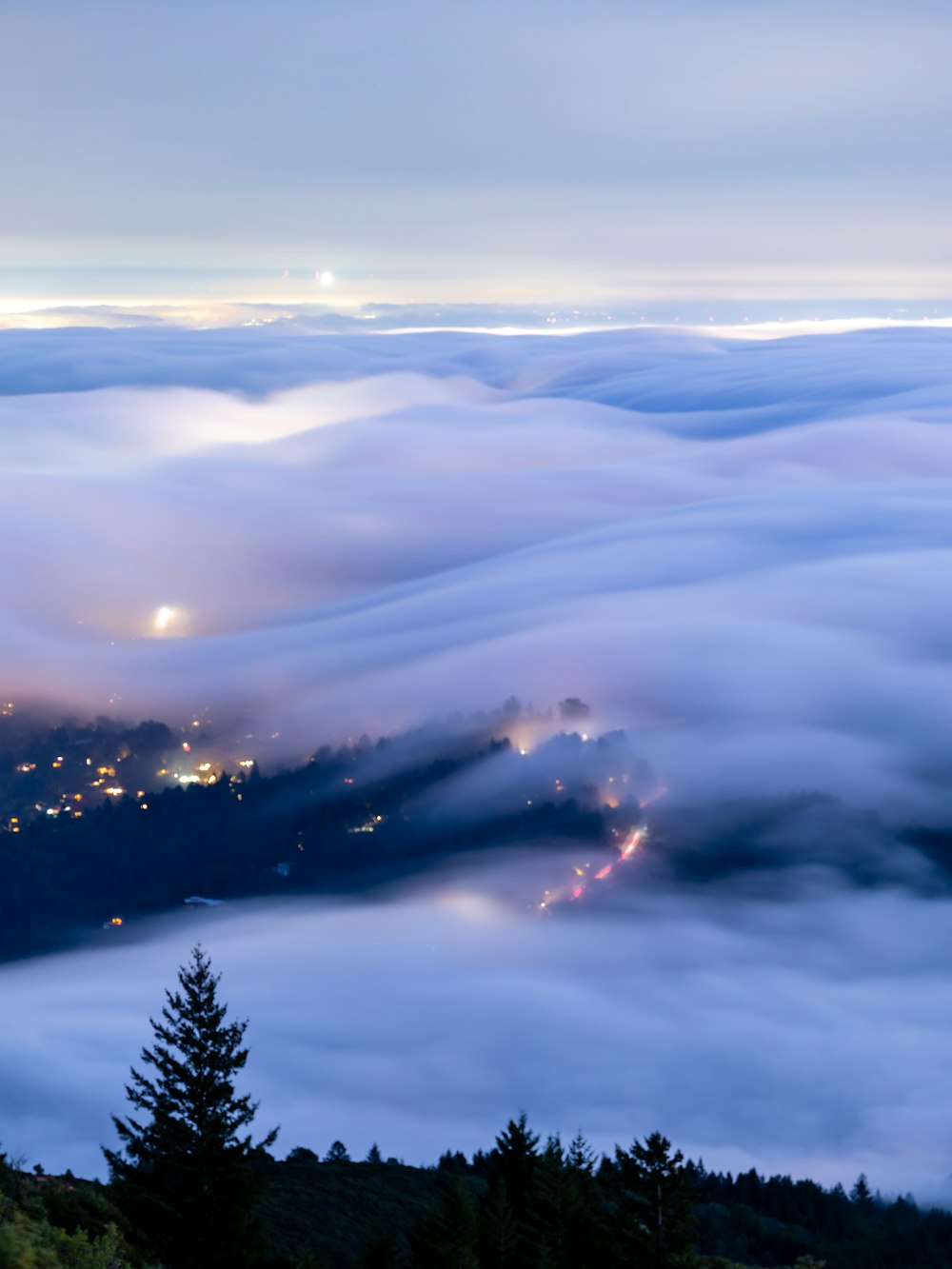 a view of a city in the distance from above the clouds