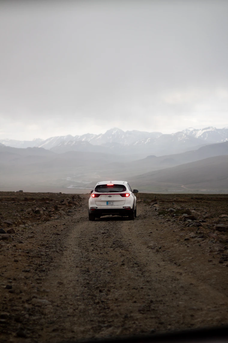 A vehicle on the open dirt road across the Deosai plateau