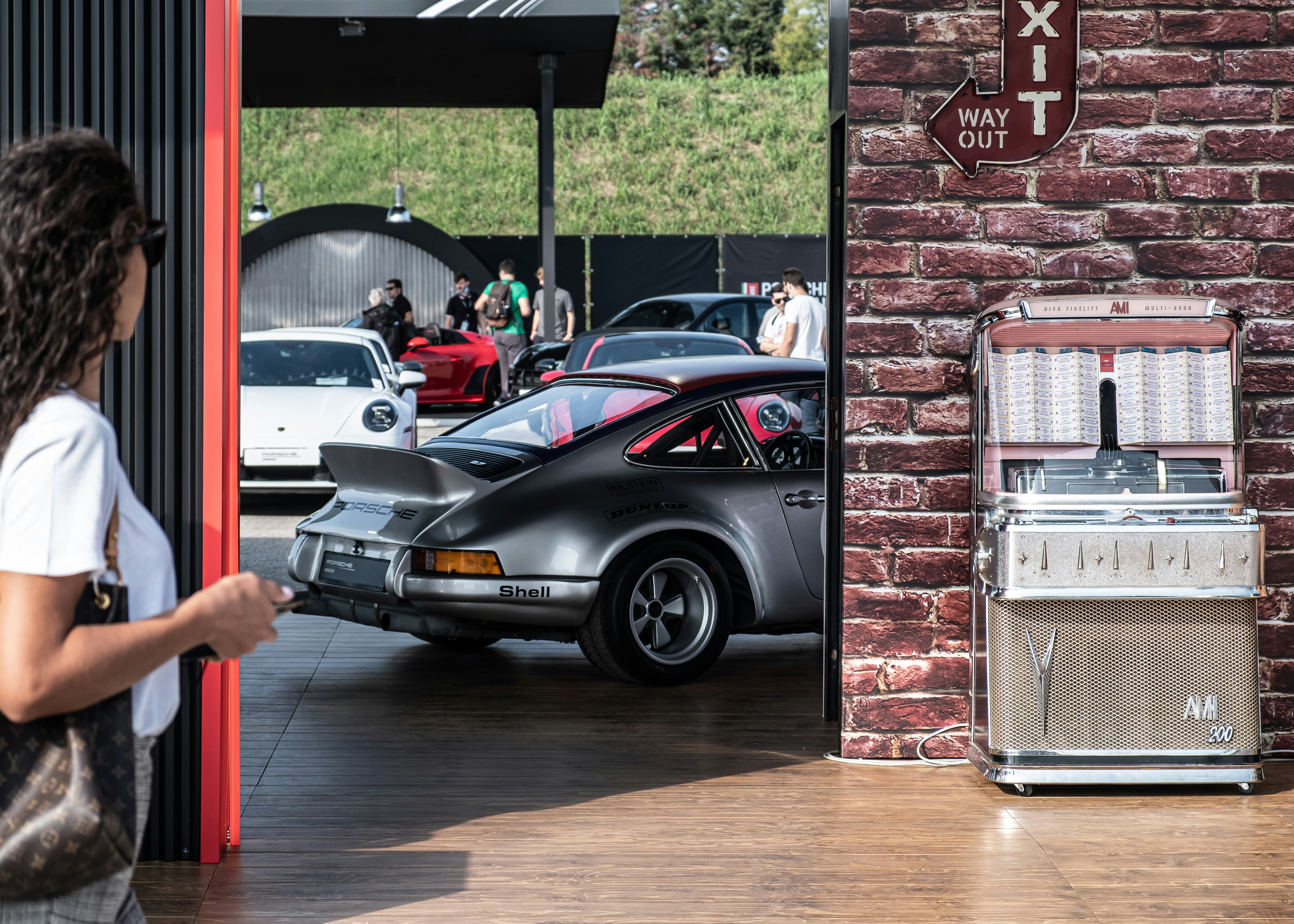 Electric car charging in a home garage with battery status displayed on a screen