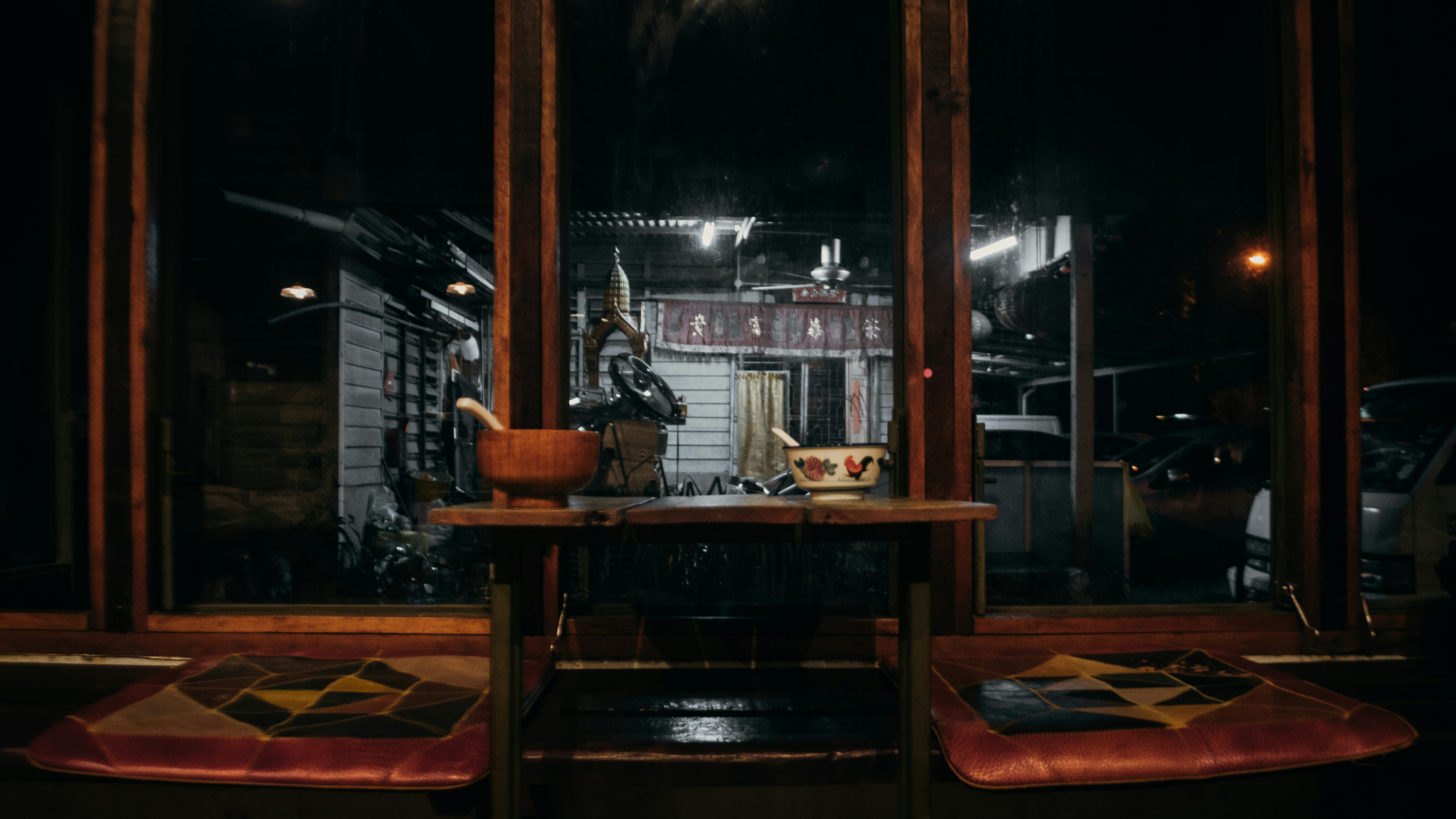 a table and two chairs in front of a window