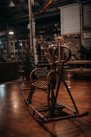 A close-up of a resin rocking chair beside a glowing rustic lantern, creating a cozy ambiance.